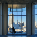 man looking outside glass window